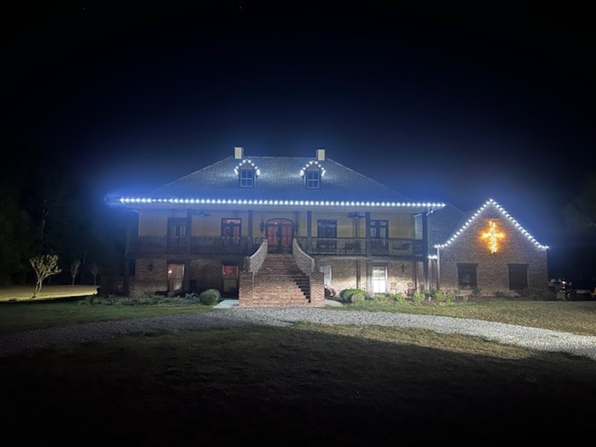 Grand estate with staircase and lit gable cross